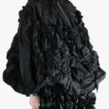 Black jacket  worn by a person, showing the jacket  fit