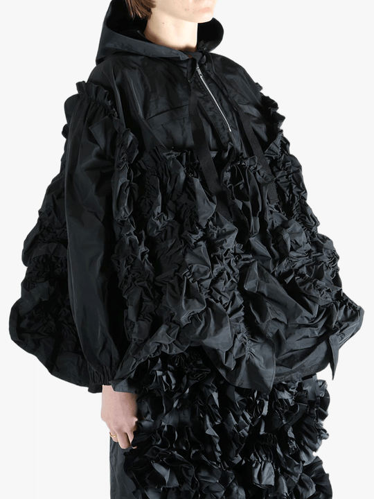 Black jacket  worn by a person, showing the jacket  fit