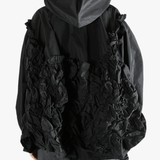 Black jacket  worn by a person, showing the jacket  fit