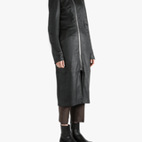 Black coat worn by a person, showing the coat fit