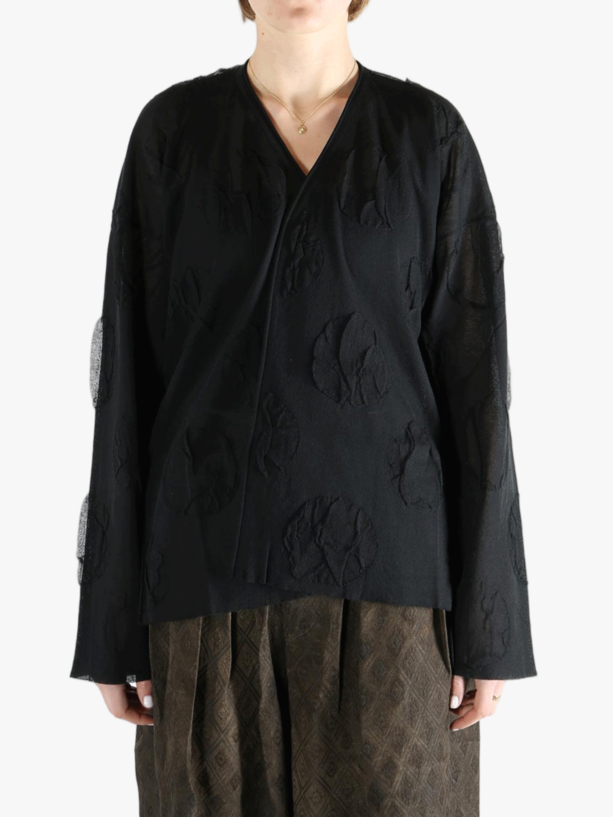 Black cardigan worn by a person, showing the cardigan fit