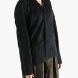 Black cardigan worn by a person, showing the cardigan fit