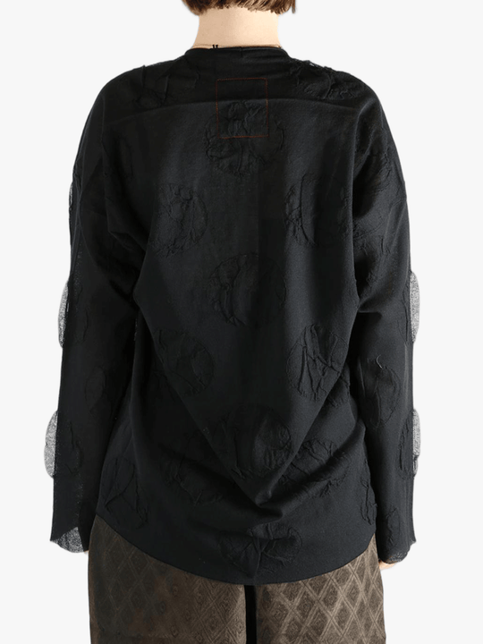 Black cardigan worn by a person, showing the cardigan fit