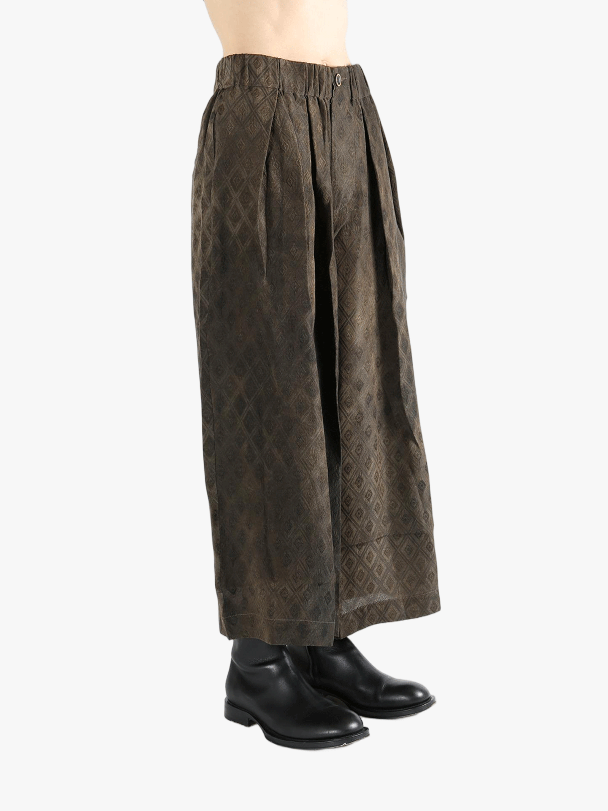 Brown pants  worn by a person, showing the pants fit