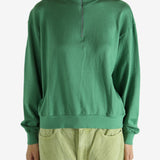 Green shirt worn by a person, showing the shirt's fit