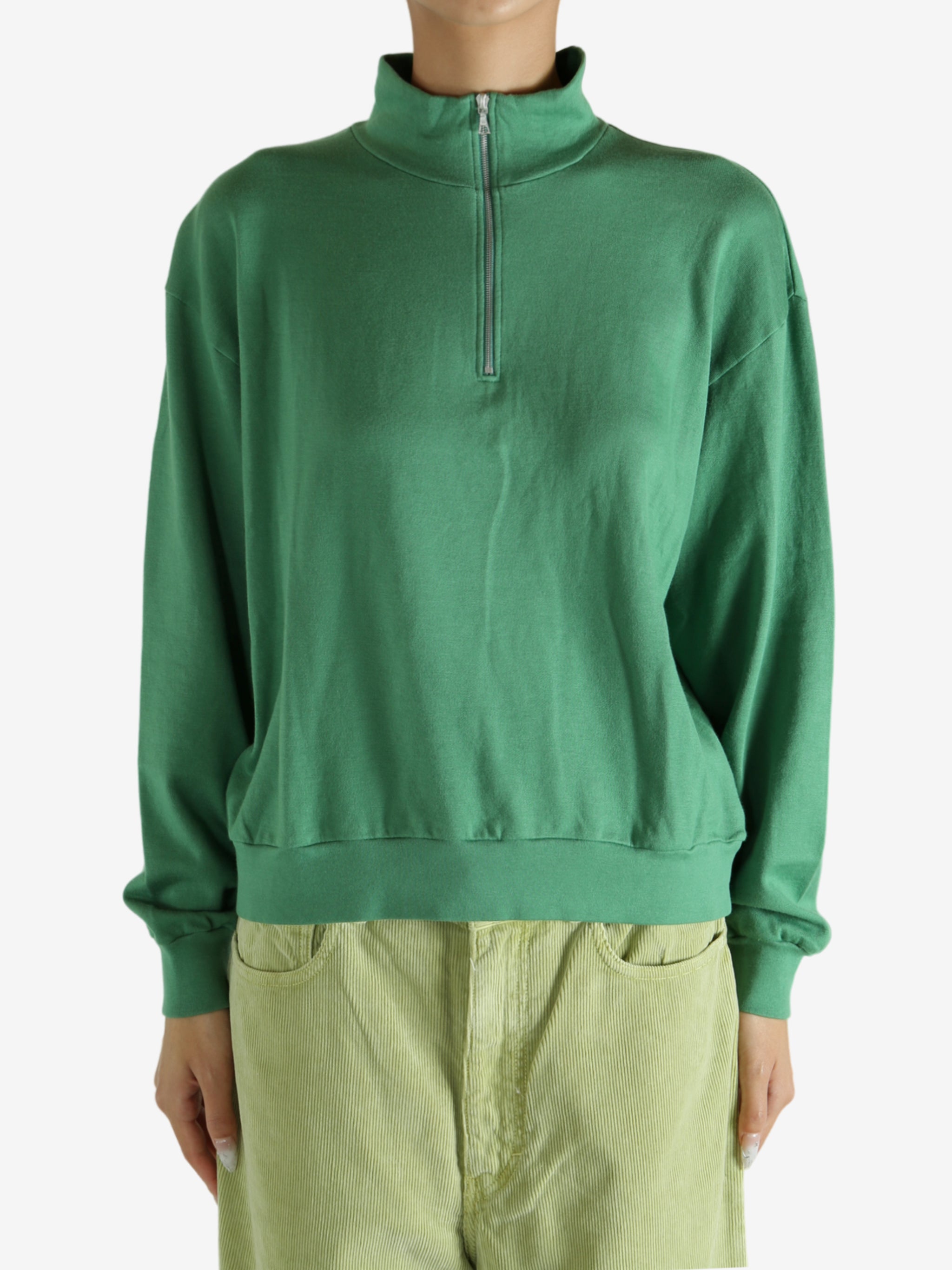 Green shirt worn by a person, showing the shirt's fit