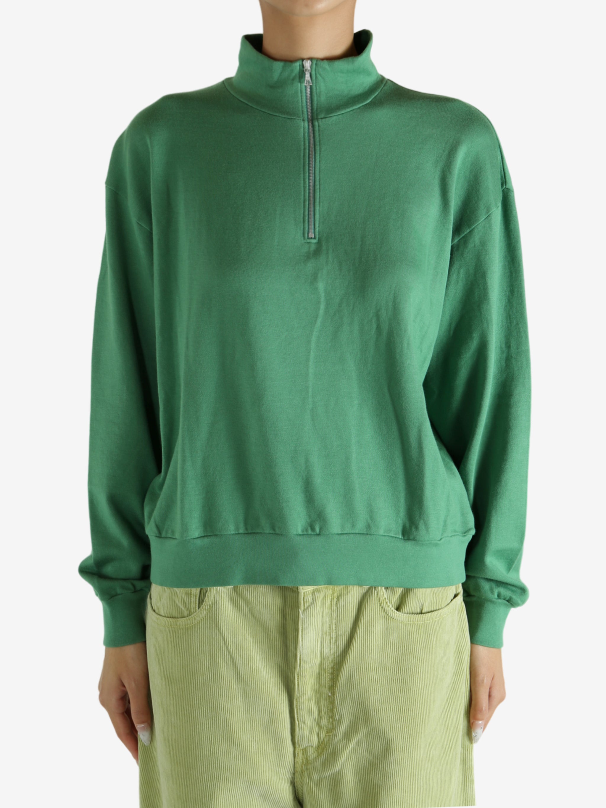 Green shirt worn by a person, showing the shirt's fit