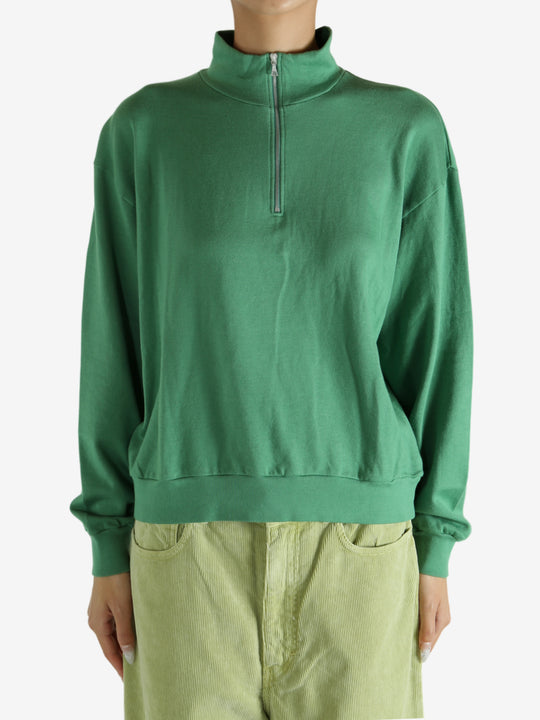 Green shirt worn by a person, showing the shirt's fit