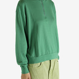 Green shirt worn by a person, showing the shirt's fit