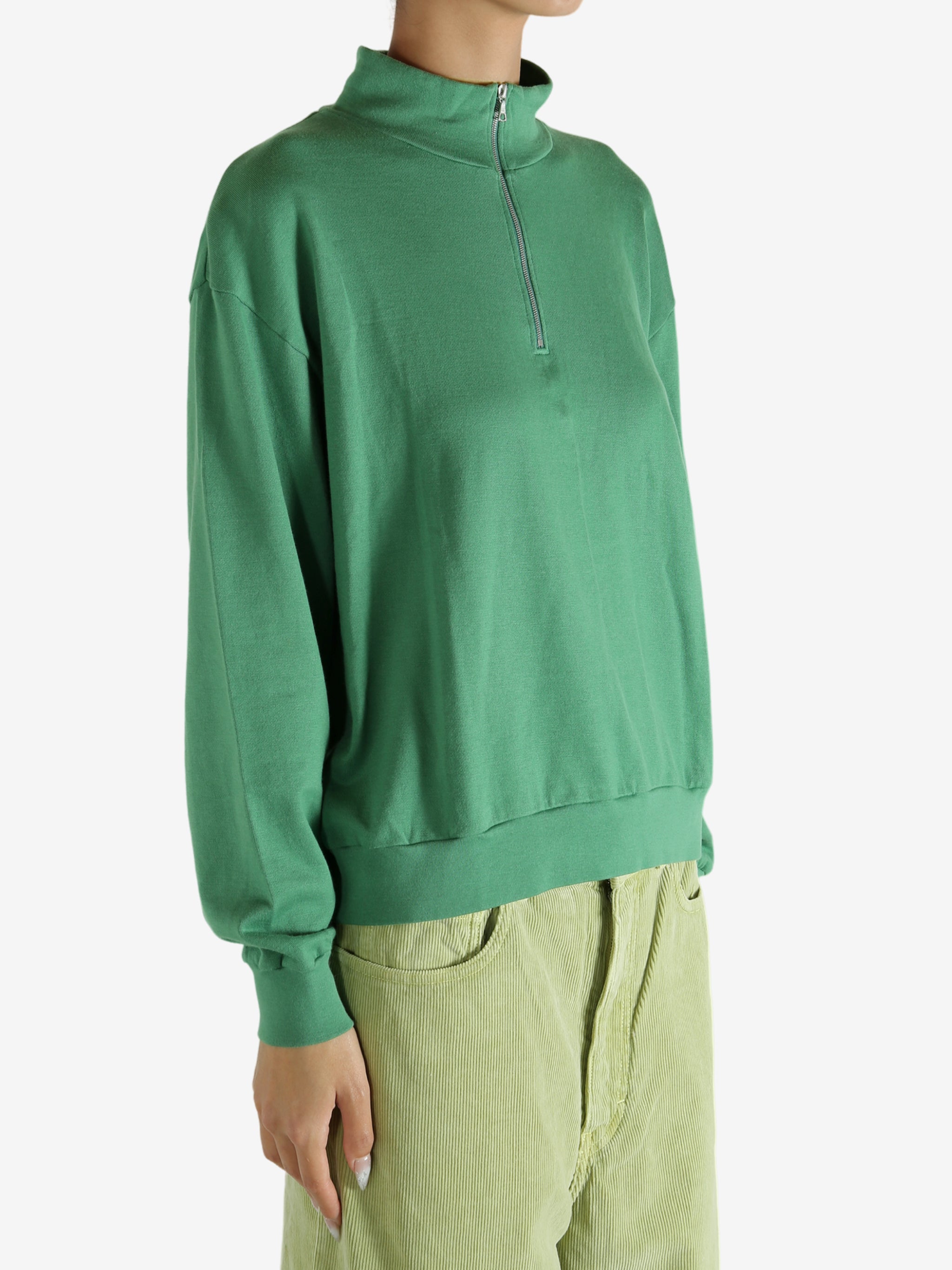 Green shirt worn by a person, showing the shirt's fit