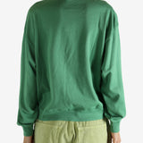 Green shirt worn by a person, showing the shirt's fit