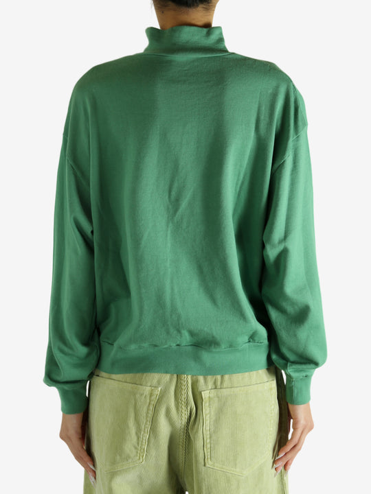 Green shirt worn by a person, showing the shirt's fit