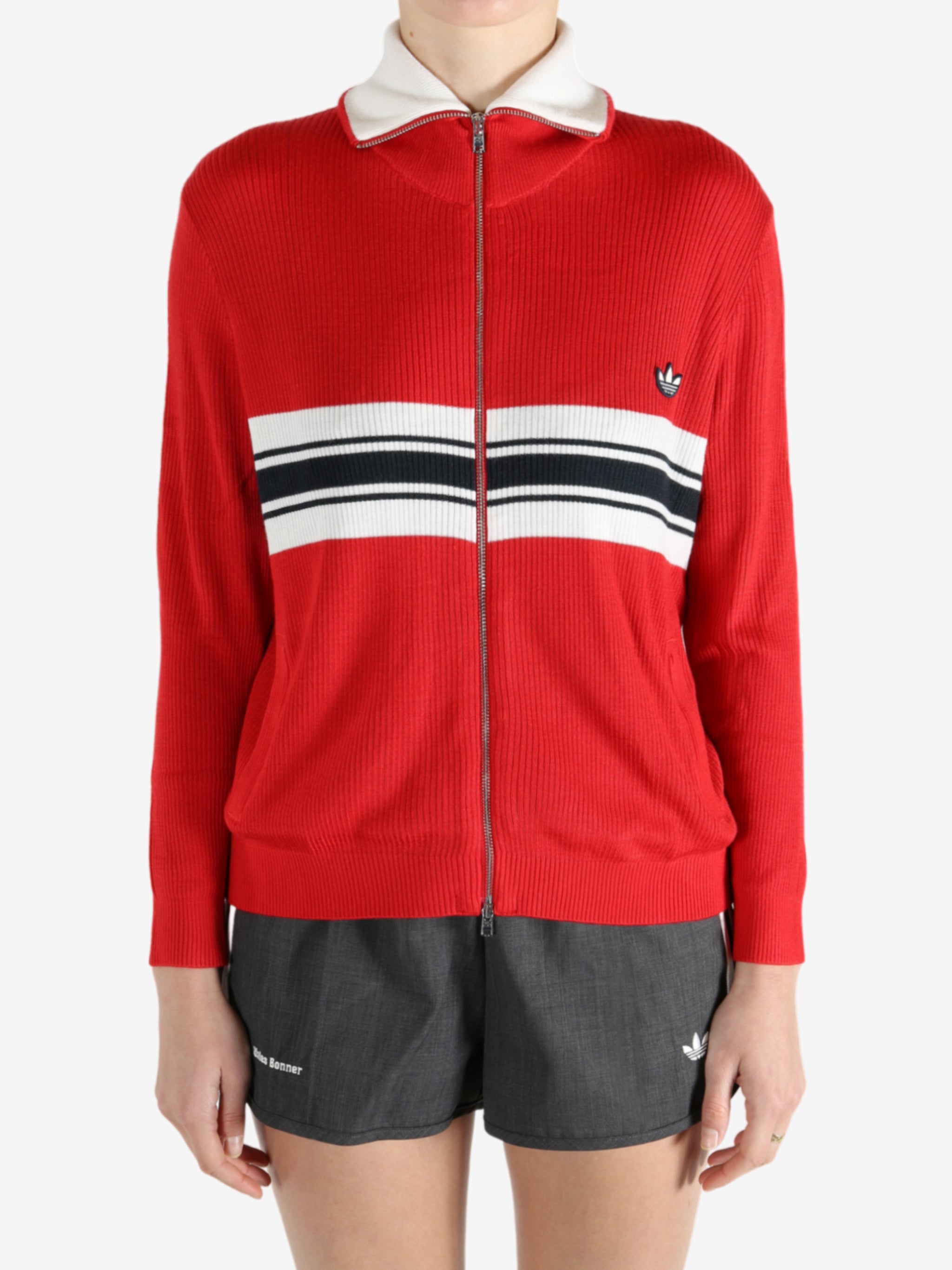 Red knitwear worn by a person, showing the knitwear fit