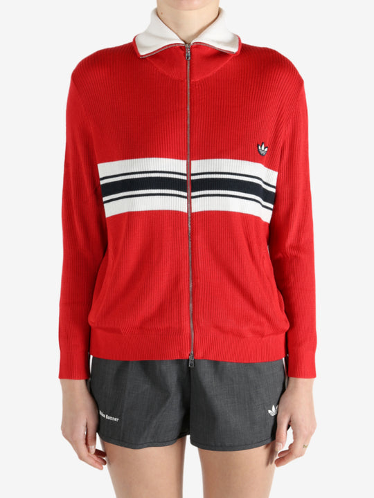 Red knitwear worn by a person, showing the knitwear fit