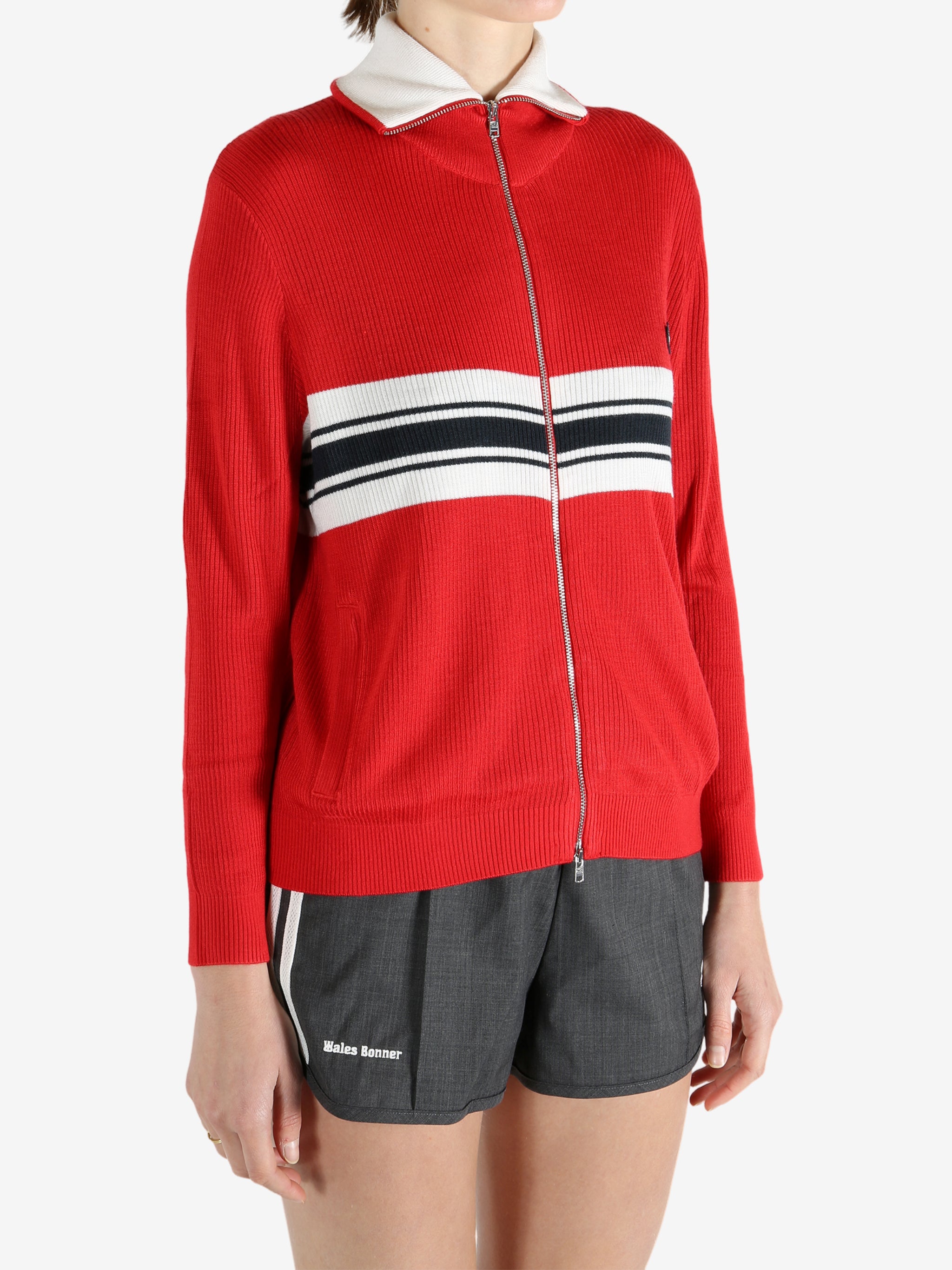 Red knitwear worn by a person, showing the knitwear fit