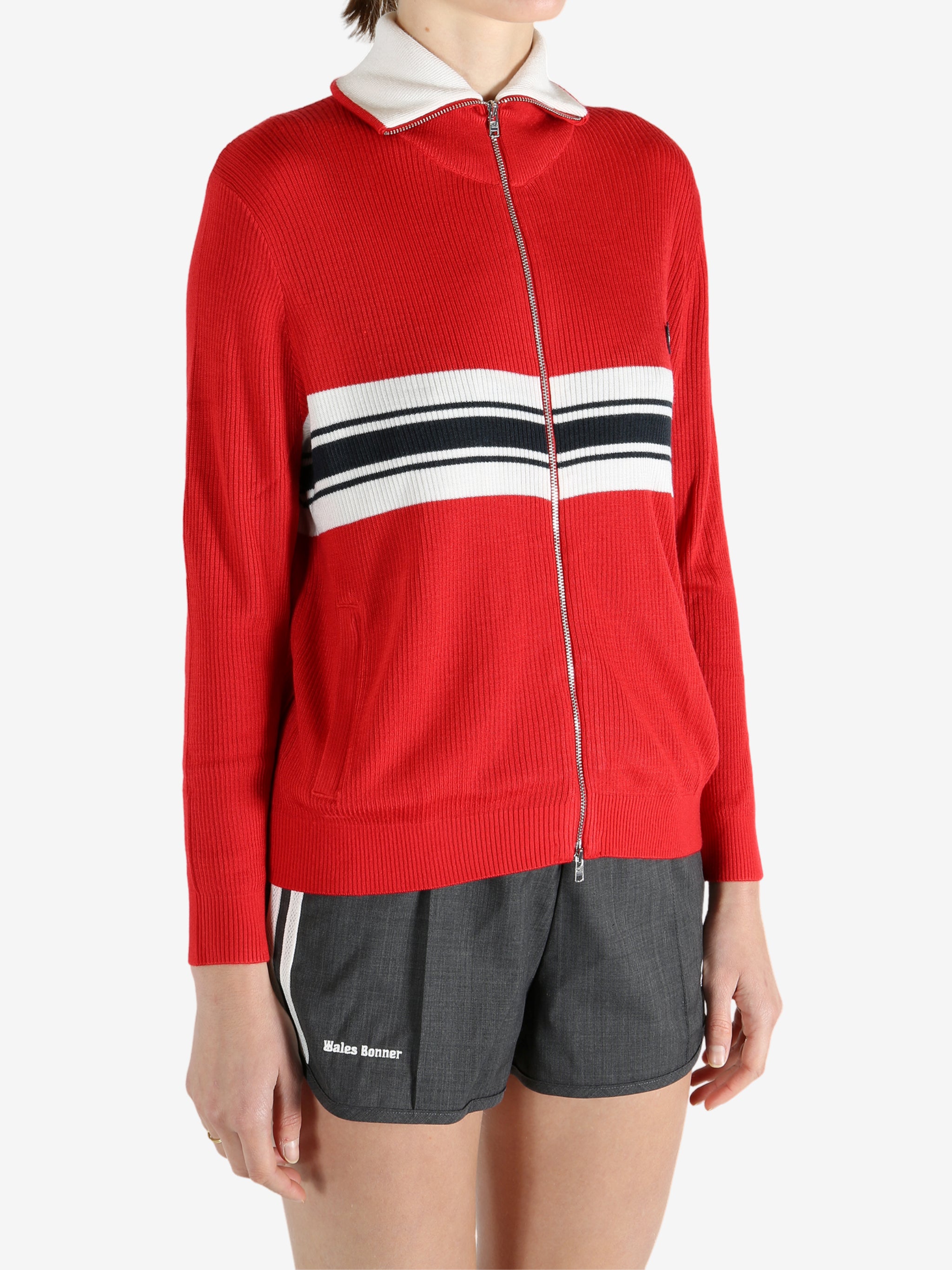 Red knitwear worn by a person, showing the knitwear fit