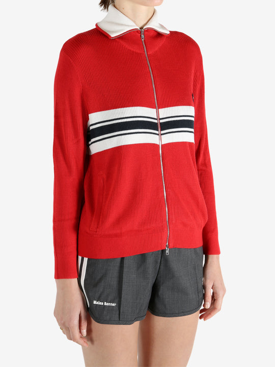 Red knitwear worn by a person, showing the knitwear fit