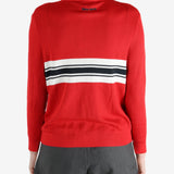 Red knitwear worn by a person, showing the knitwear fit