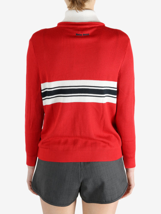 Red knitwear worn by a person, showing the knitwear fit