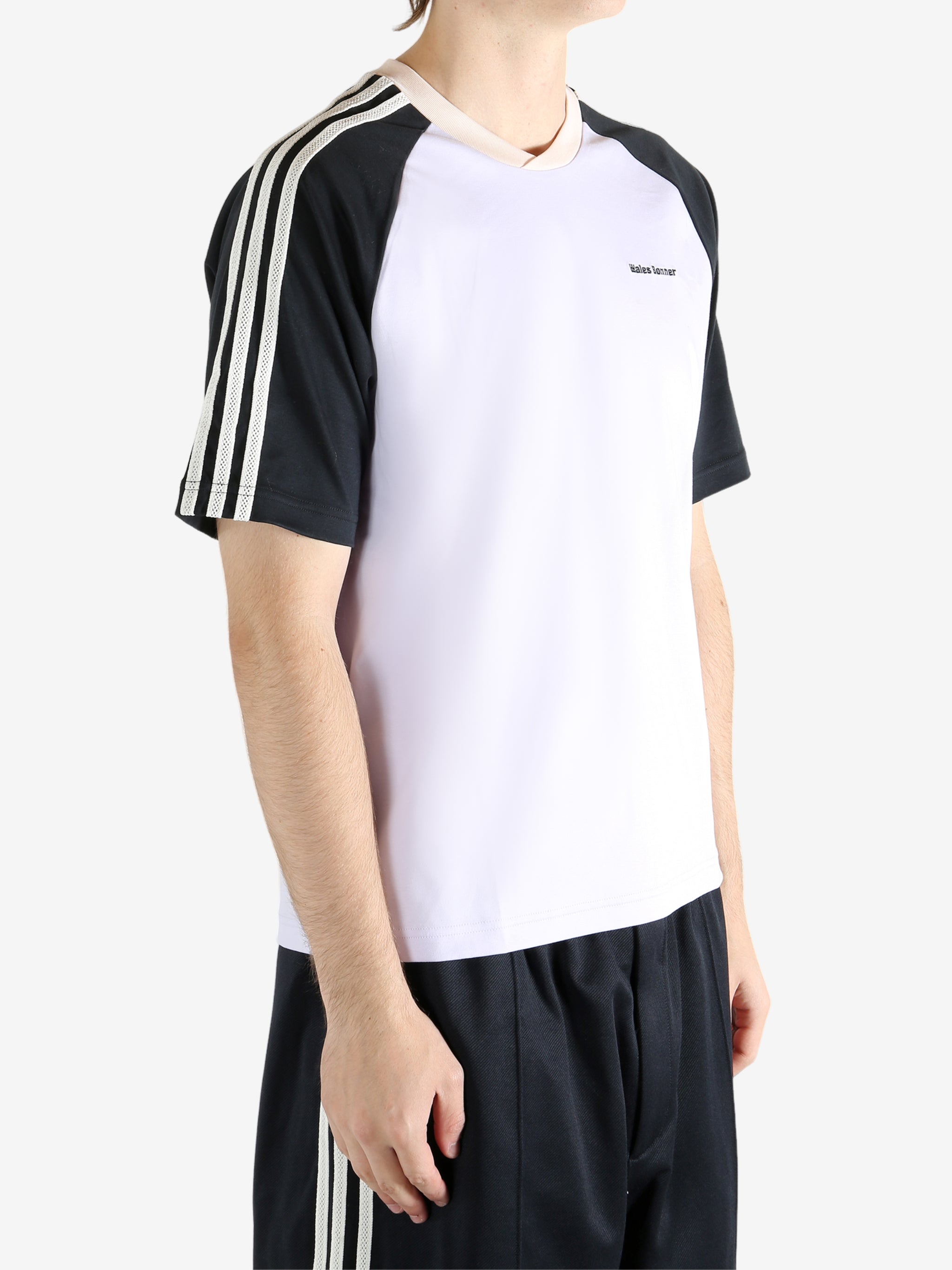 White t-shirt worn by a person, showing the t-shirt fit