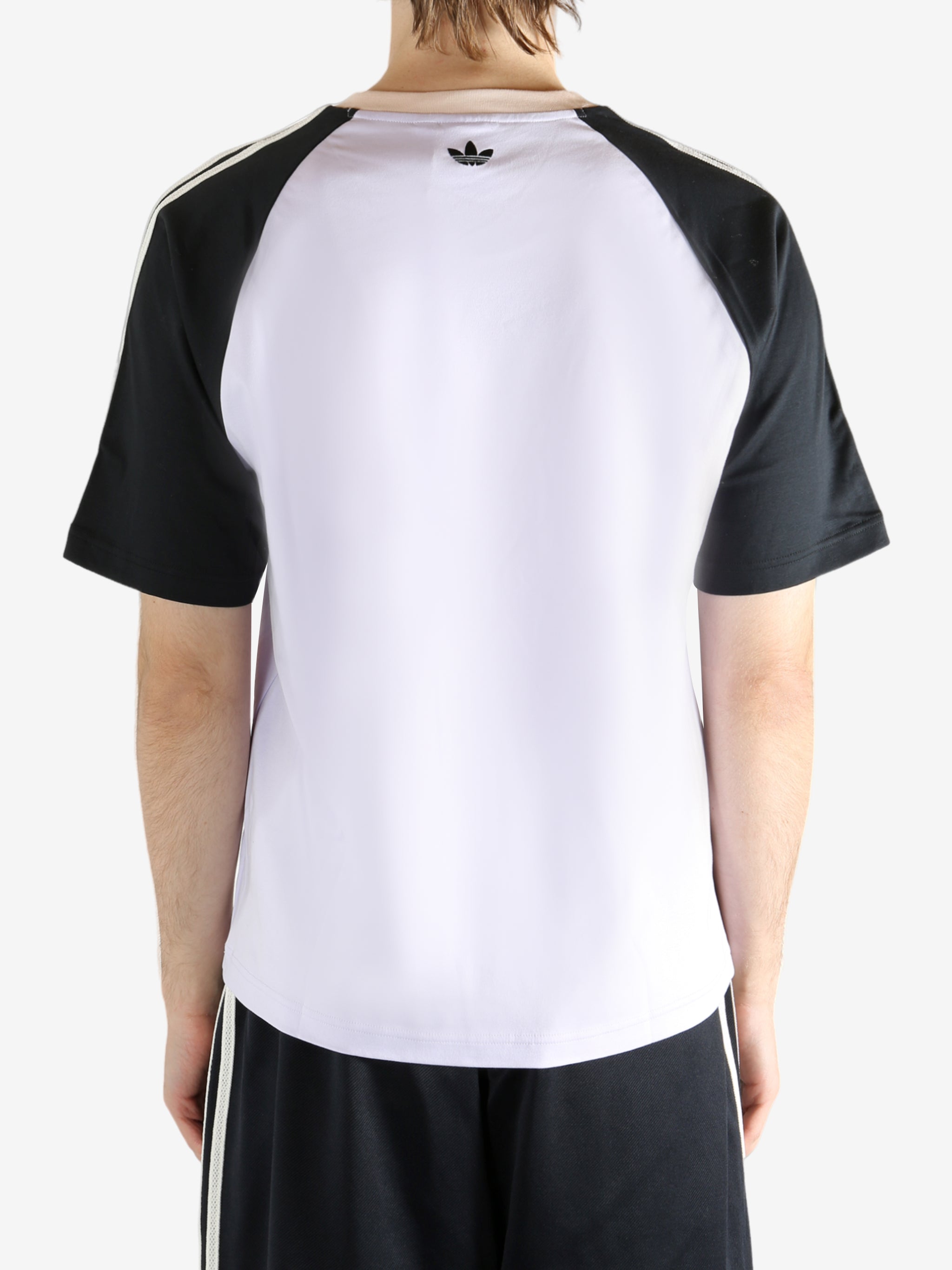 White t-shirt worn by a person, showing the t-shirt fit