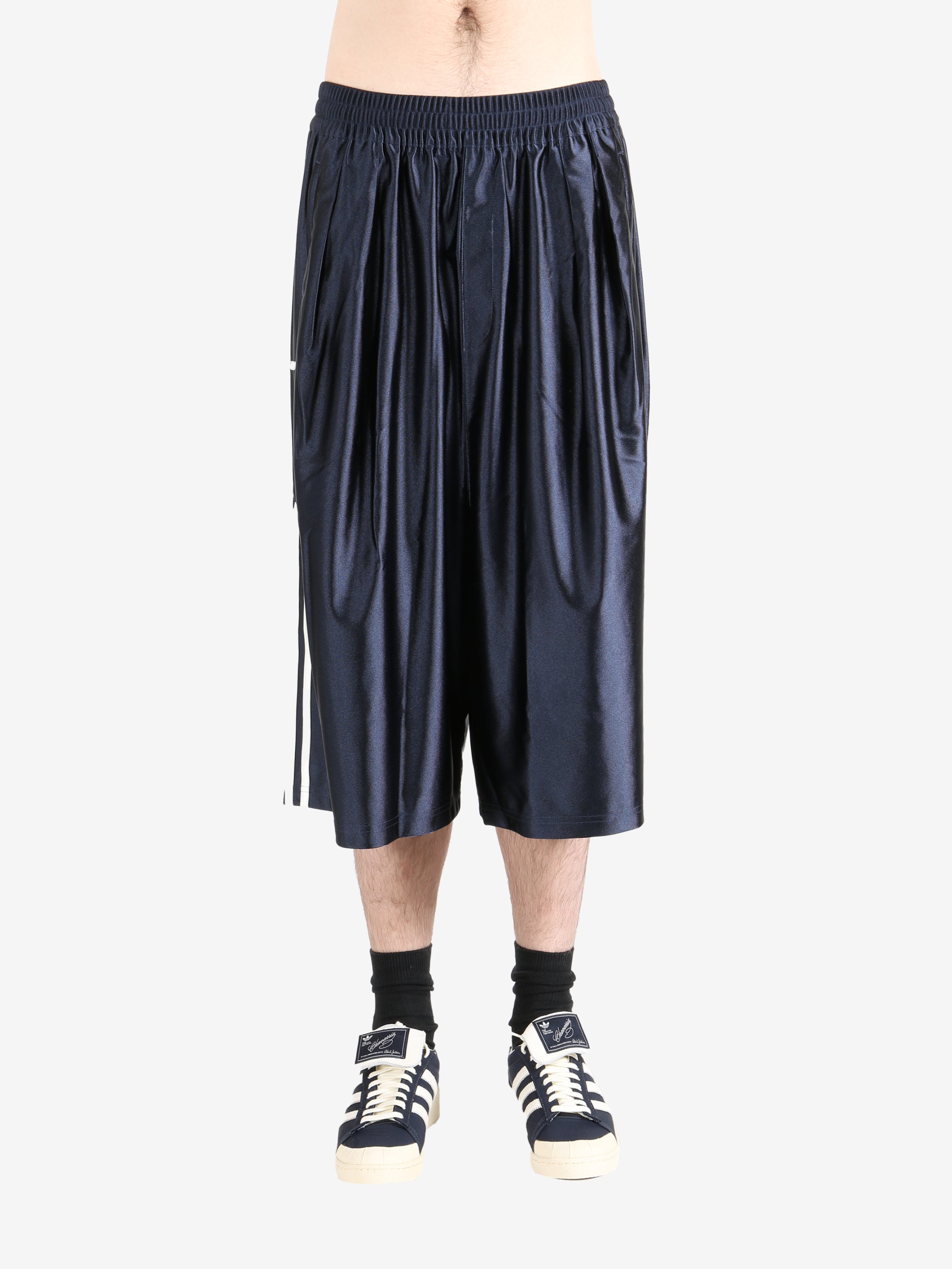 Navy pants worn by a person, showing the  pants fit