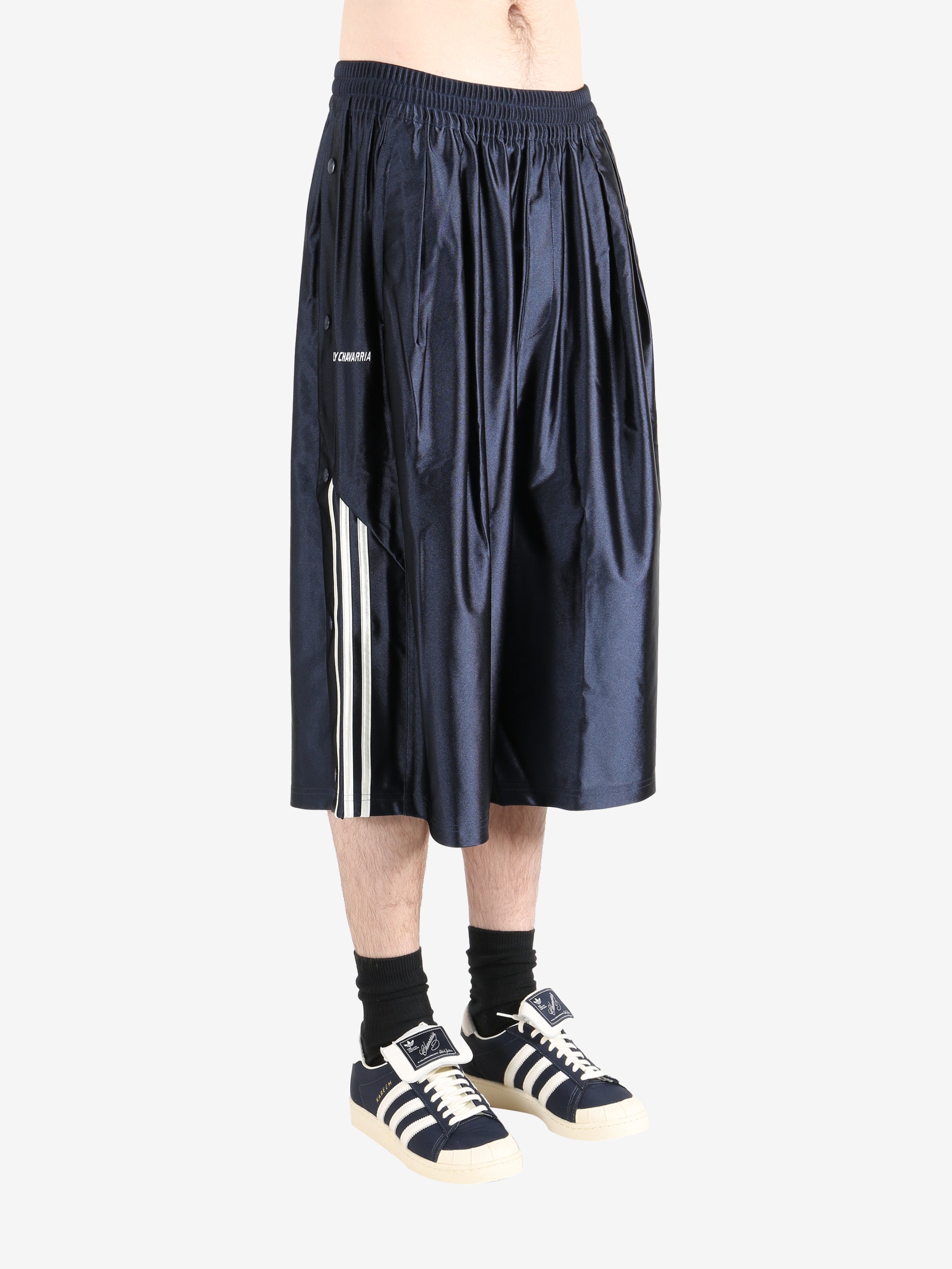 Navy pants worn by a person, showing the  pants fit