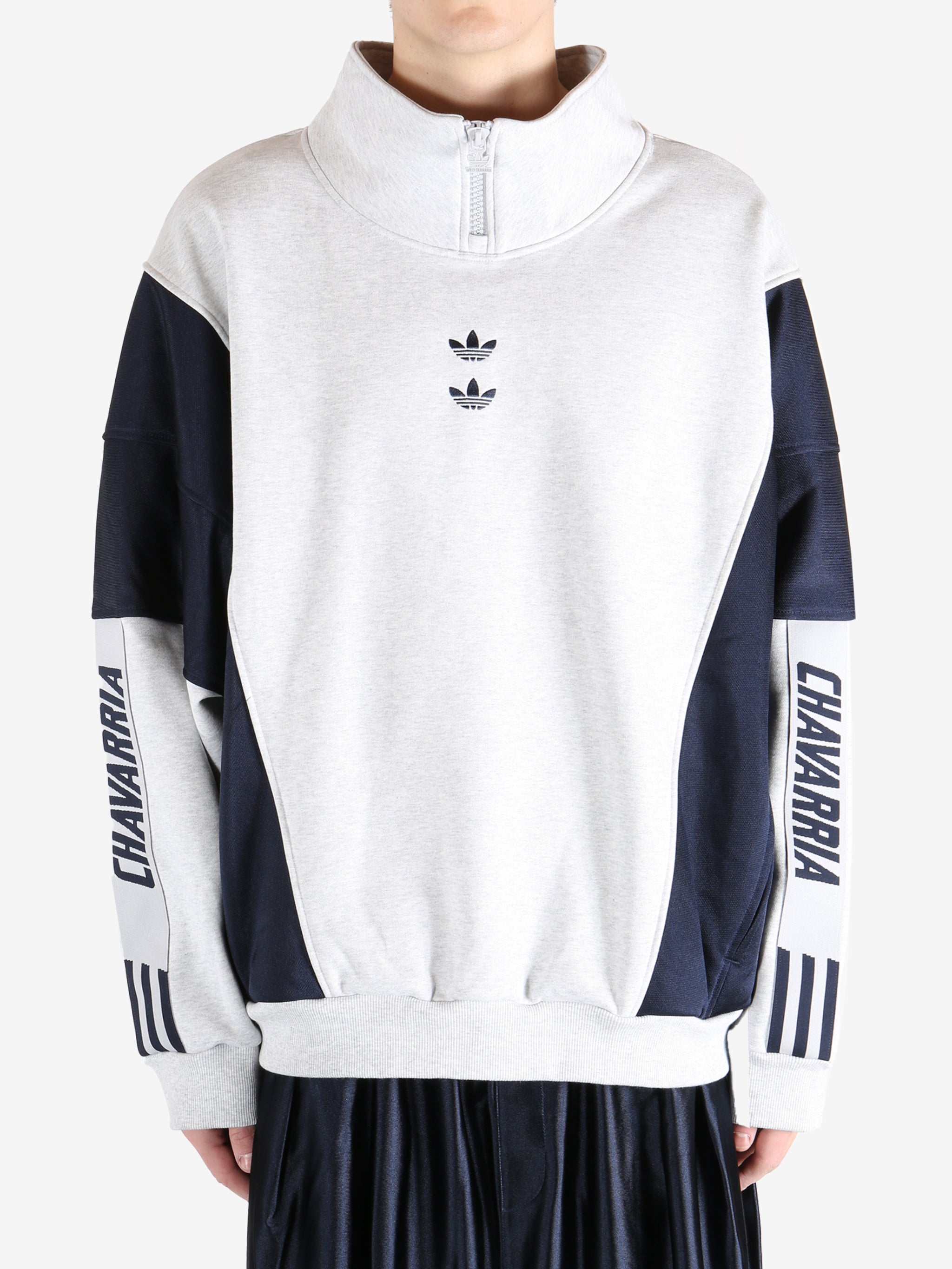 White tops by a person, showing the  tops fit