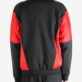 Black coat worn by a person, showing the coat's fit