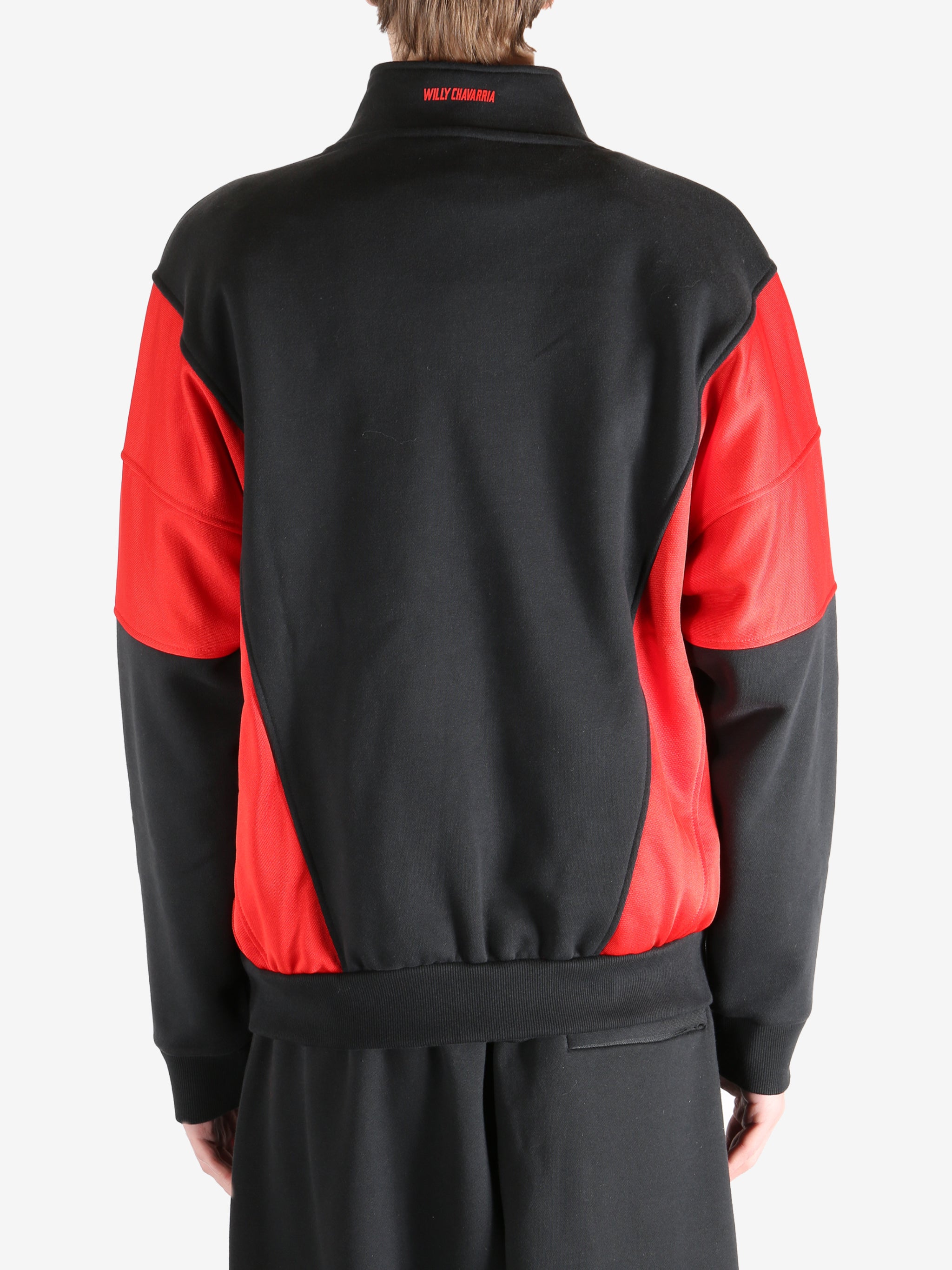 Black coat worn by a person, showing the coat's fit