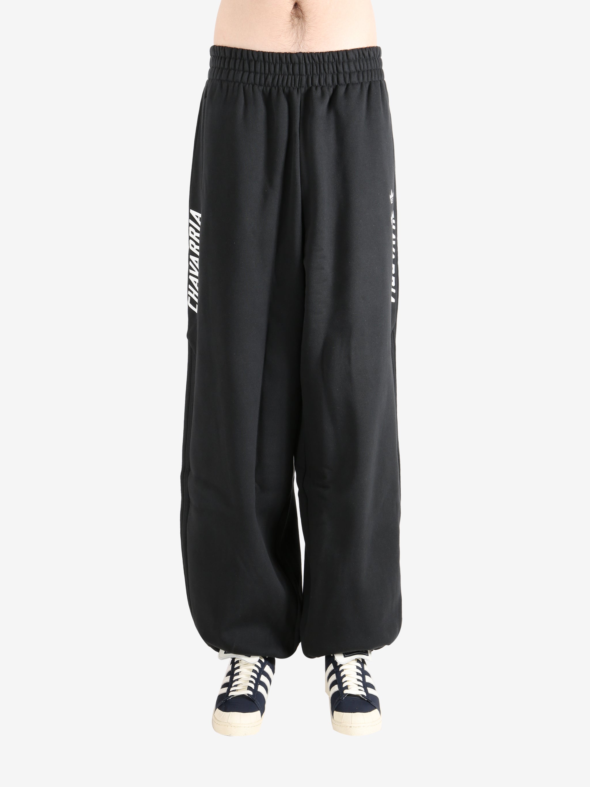 Black pants worn by a person, showing the  pants fit