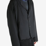 Black jacket worn by a person, showing the jacket's fit