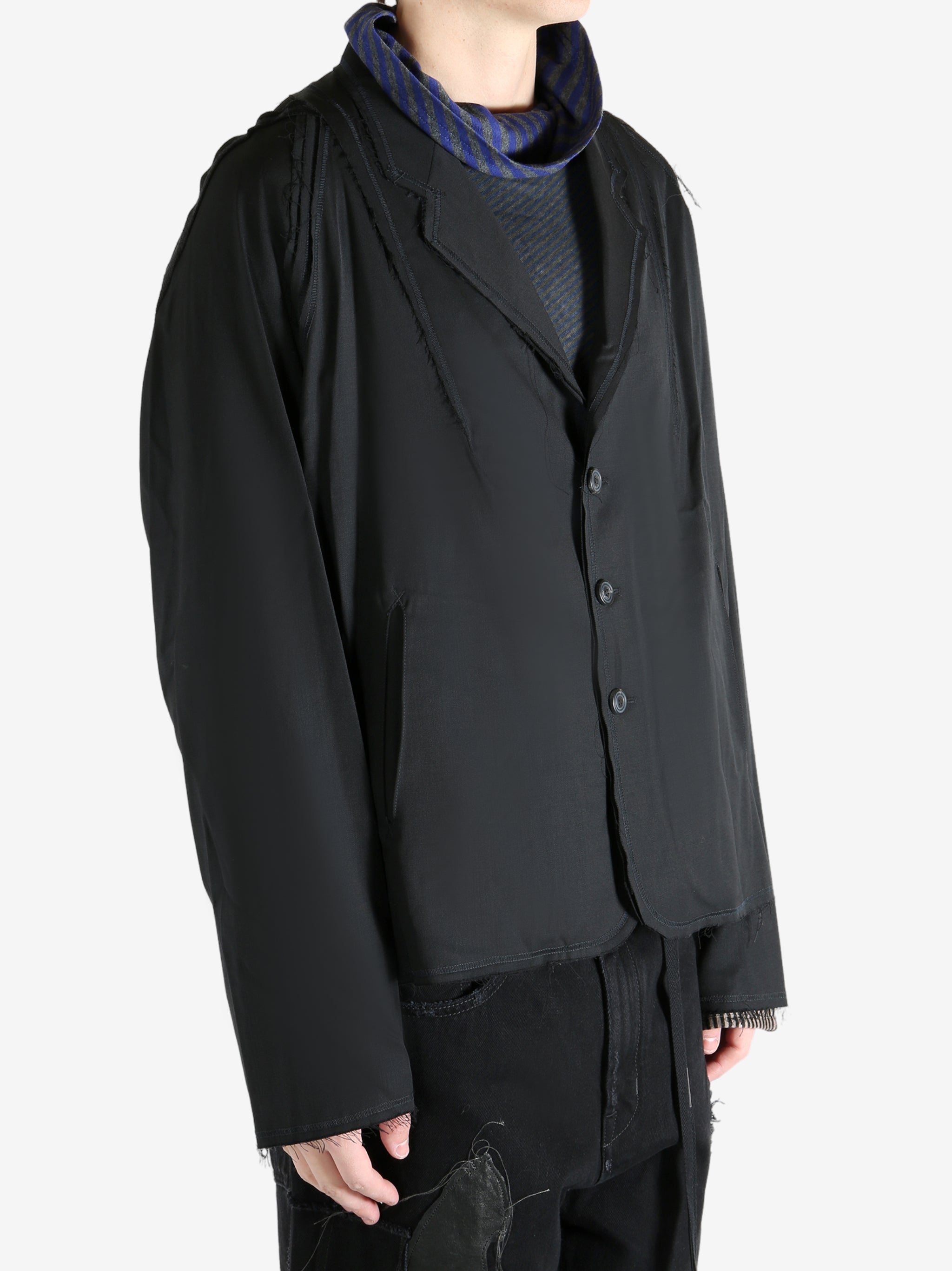 Black jacket worn by a person, showing the jacket's fit