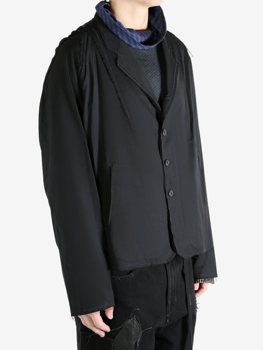 Black jacket worn by a person, showing the jacket's fit