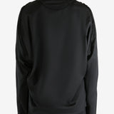 Black jacket worn by a person, showing the jacket's fit