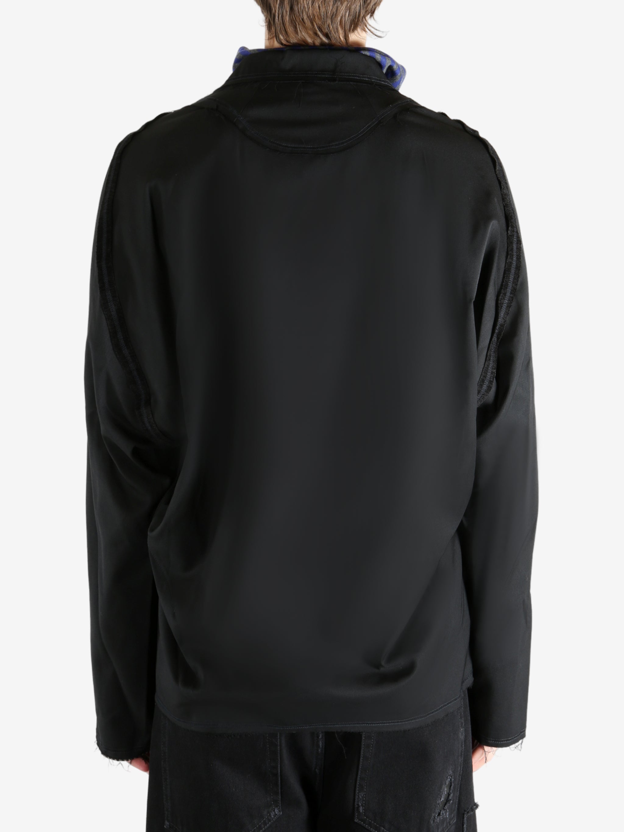 Black jacket worn by a person, showing the jacket's fit