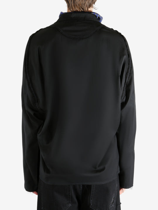 Black jacket worn by a person, showing the jacket's fit