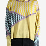 Yellow top worn by a person, showing the top's fit