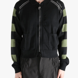 Black knitwear worn by a person, showing the knitwear fit