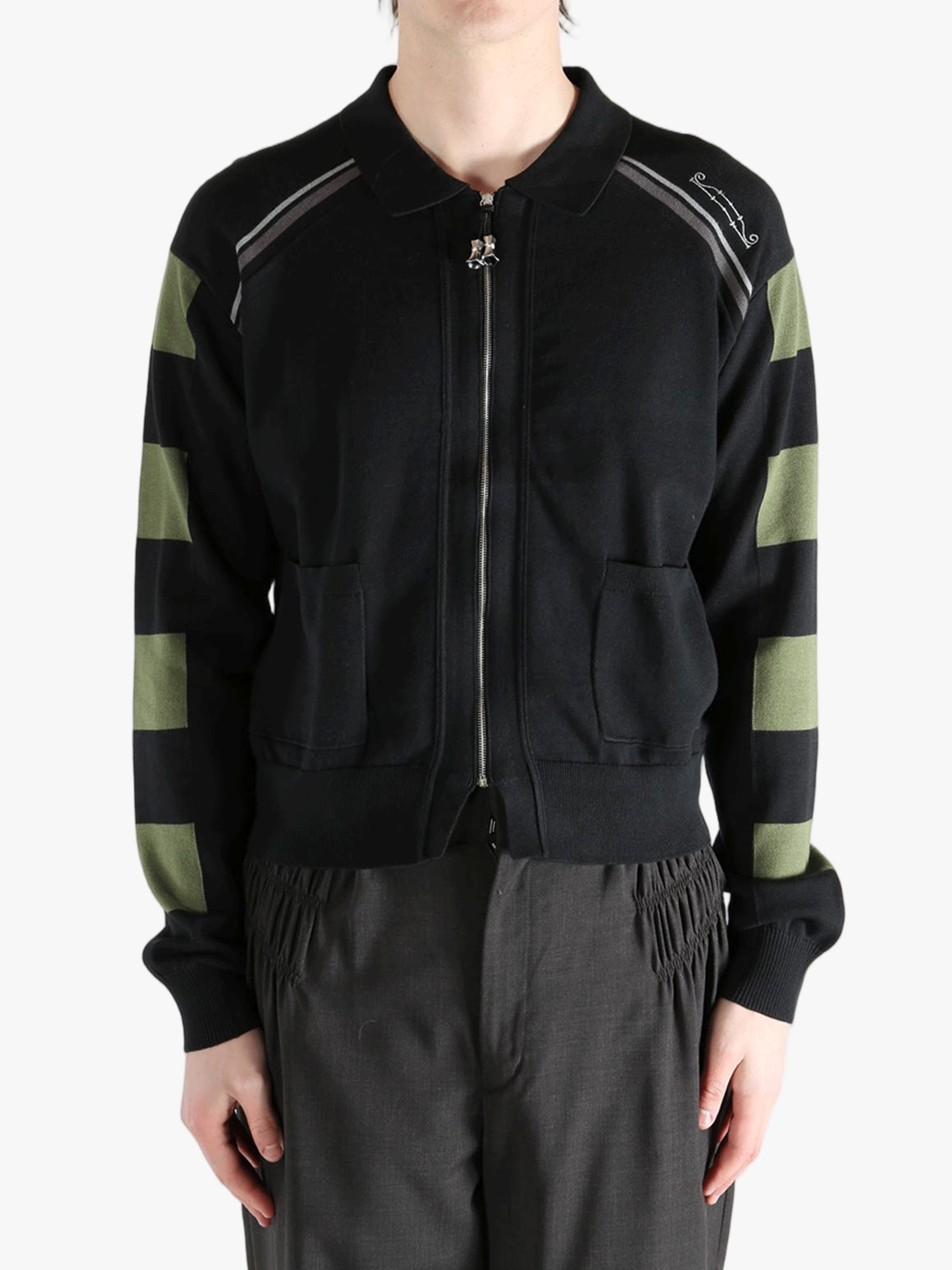 Black knitwear worn by a person, showing the knitwear fit