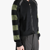 Black knitwear worn by a person, showing the knitwear fit