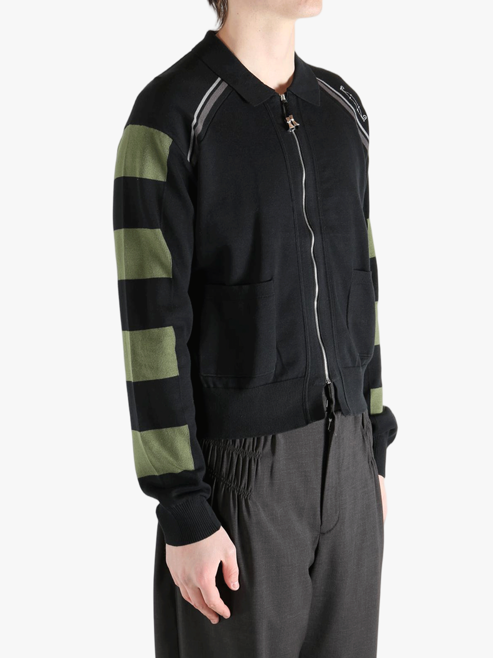 Black knitwear worn by a person, showing the knitwear fit