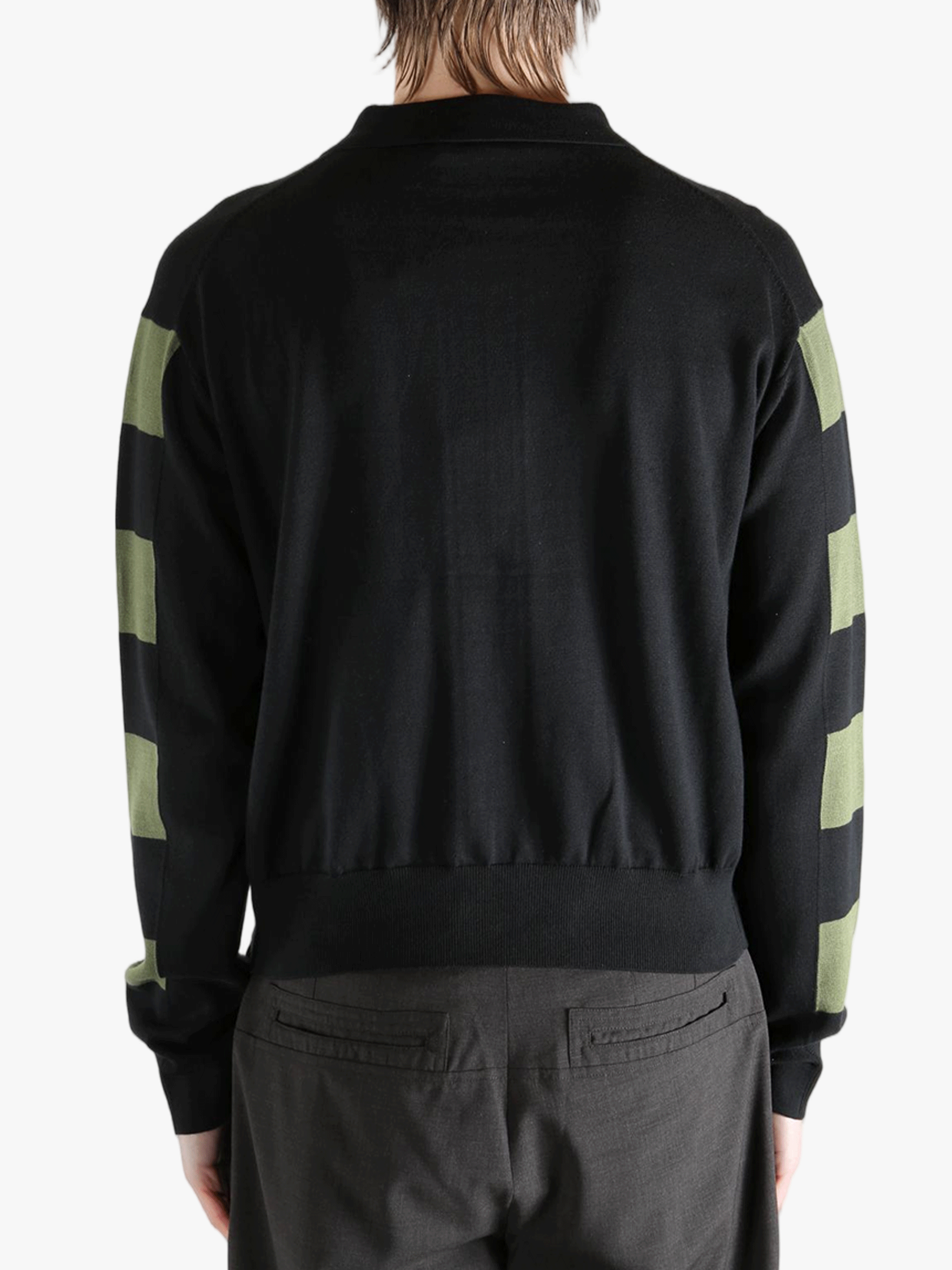 Black knitwear worn by a person, showing the knitwear fit