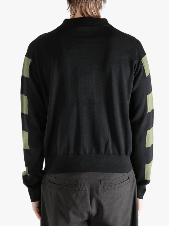 Black knitwear worn by a person, showing the knitwear fit