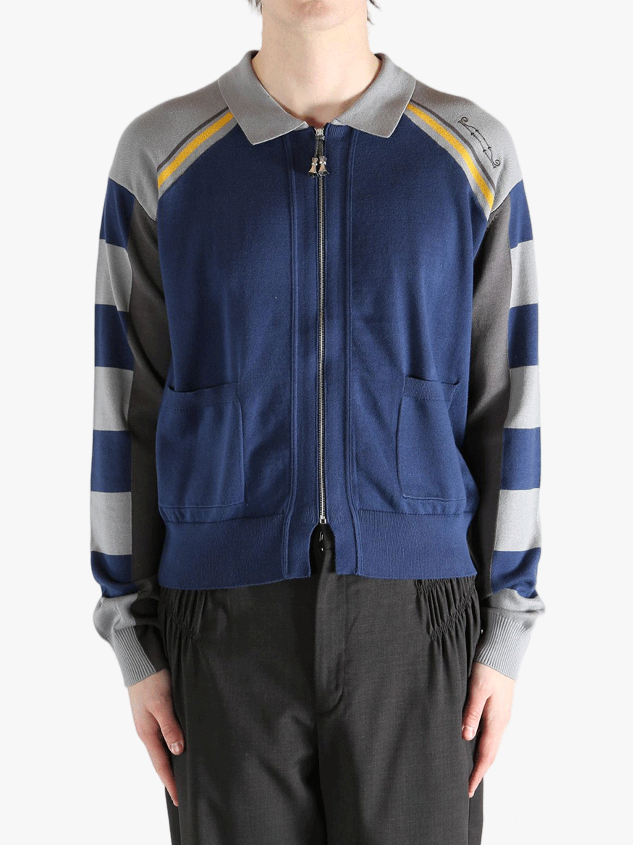 Navy knitwear worn by a person, showing the knitwear fit