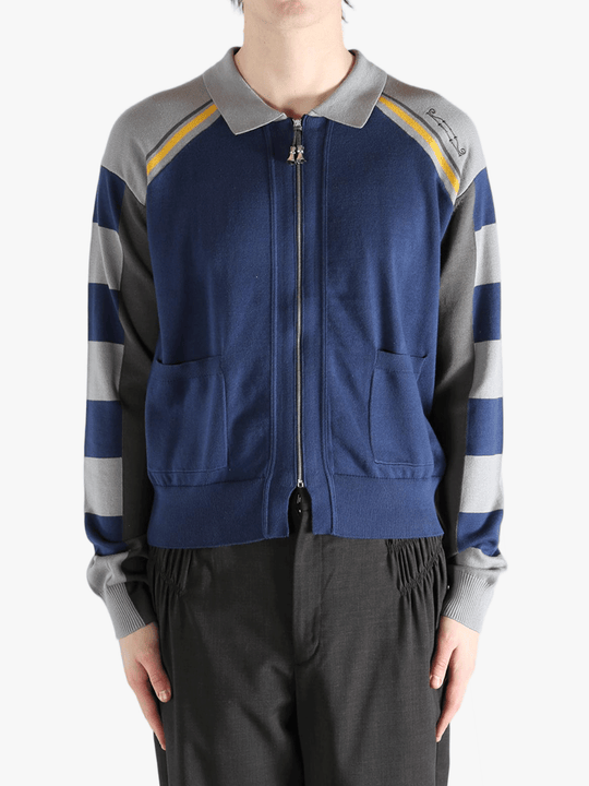 Navy knitwear worn by a person, showing the knitwear fit