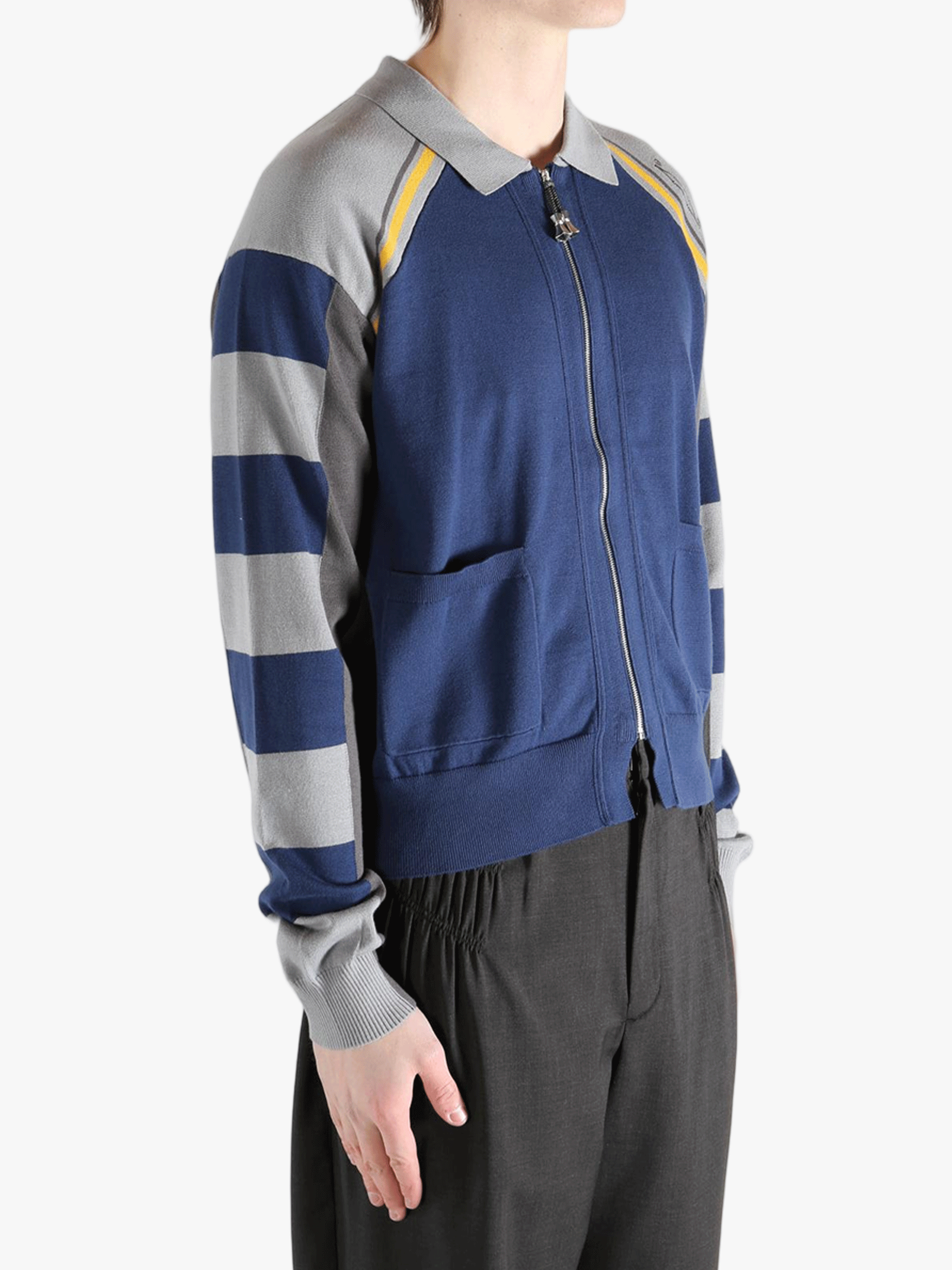 Navy knitwear worn by a person, showing the knitwear fit