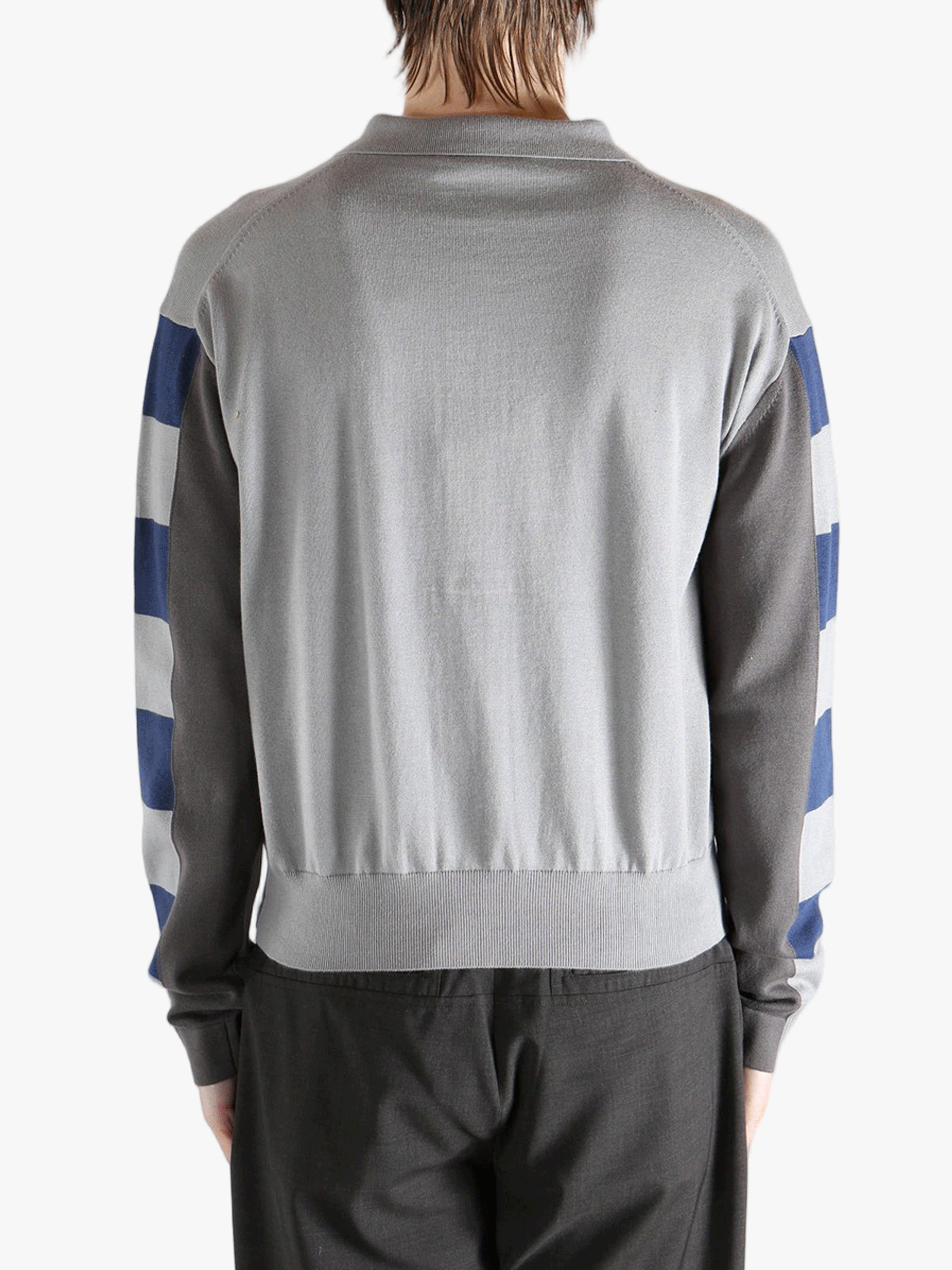 Navy knitwear worn by a person, showing the knitwear fit