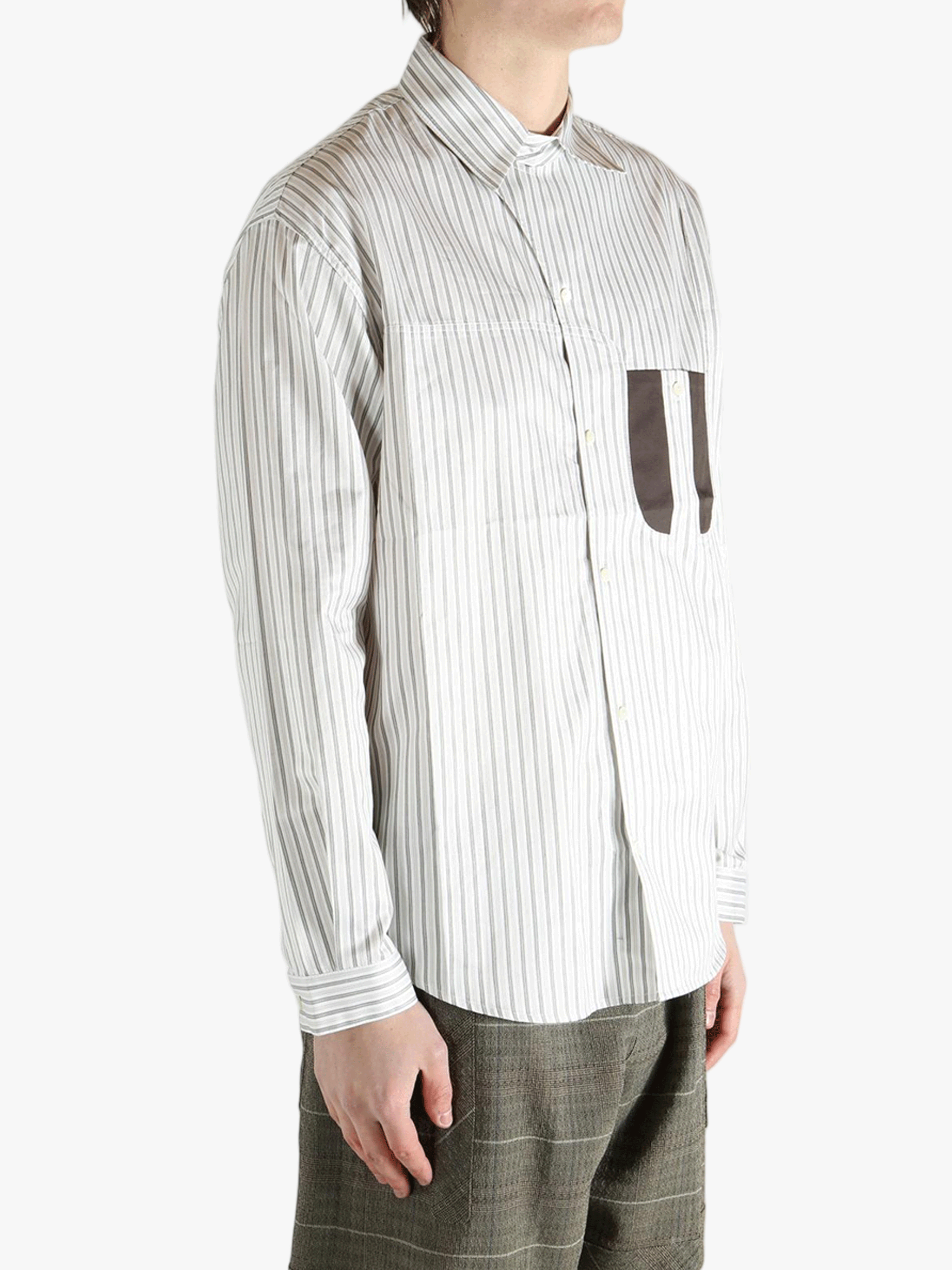 White shirt worn by a person, showing the shirt's fit