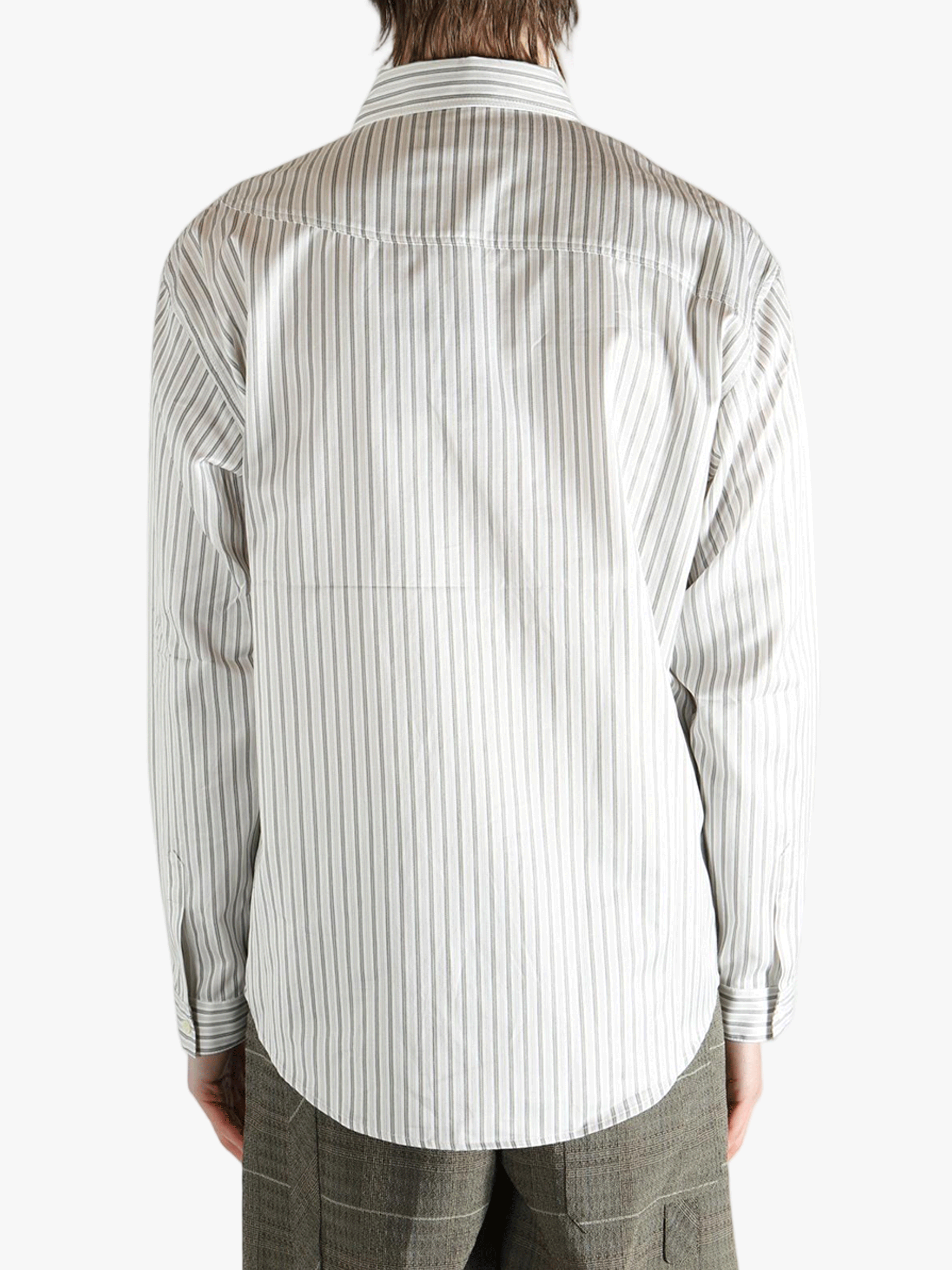 White shirt worn by a person, showing the shirt's fit